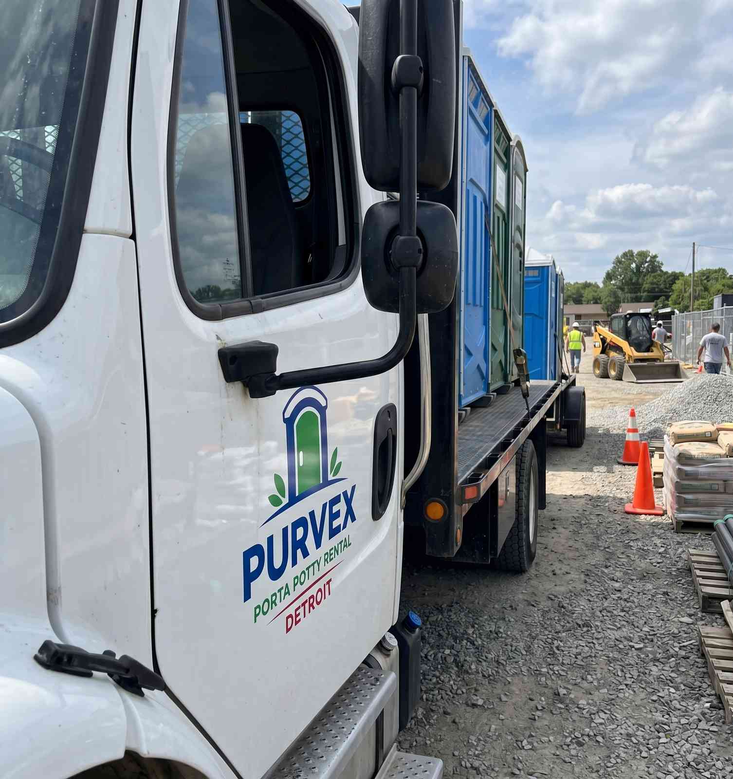 Purvex Porta Potty Rental Detroit delivery truck at a construction site
